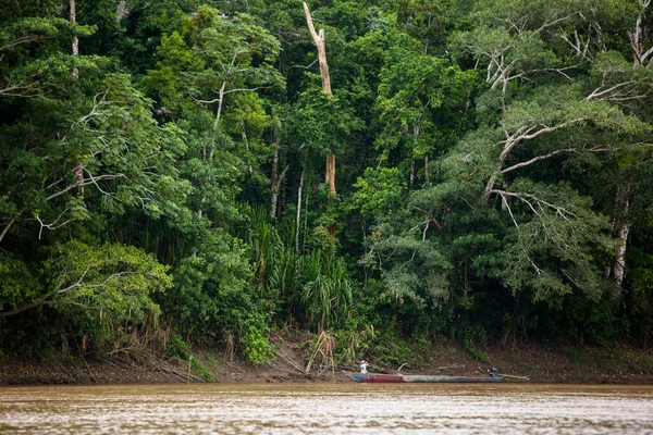 Image in Peruvian jungle of a boat in a river in Amazon forest. Traditional way of transportation in tropical rivers in Peru.
