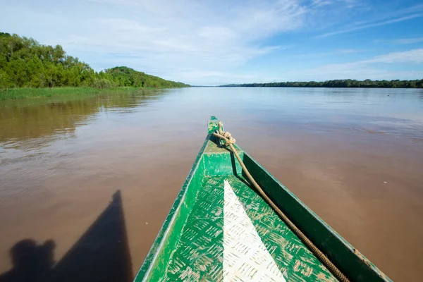 Image in Peruvian jungle of a boat in a river in Amazon forest. Traditional way of transportation in tropical rivers in Peru.