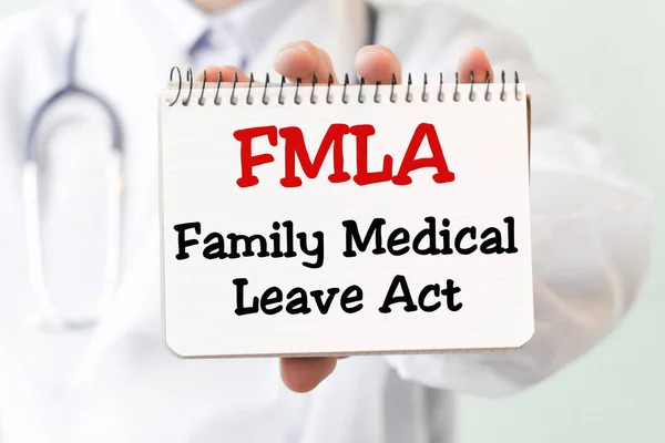 Doctor holding a card with text FMLA Family Medical Leave Act medical concept.