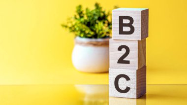 Motivasyon Sözcükleri: 3d tahta alfabe harfli B2C, kopyalama alanı olan parlak sarı bir zemin üzerinde. İşletmeden tüketiciye, kavram
