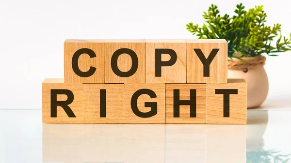 Copy Right word written on wood block. Search engine optimization. Faqs text on table, concept