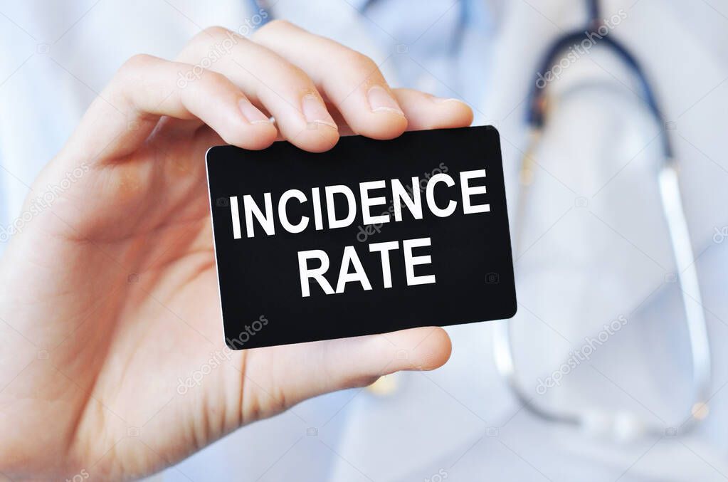 Doctor holding a black paper card with text incidence rate, medical concept. incidence rate card in hands of medical doctor