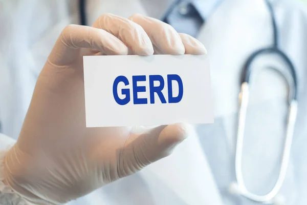 Doctor holding a white paper card with text Gerd, medical concept. Healthcare conceptual for hospital, clinic and medical busines.