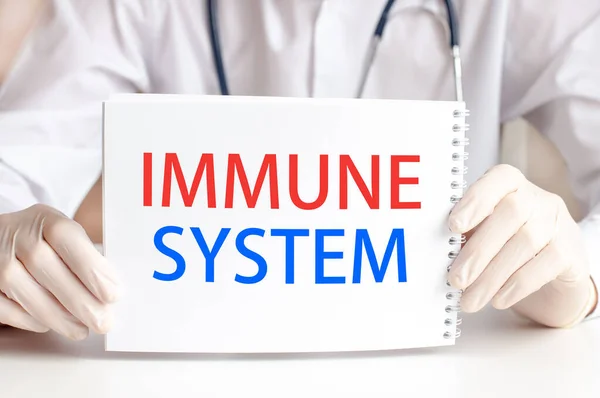 Doctor showing a card with text IMMUNE SYSTEM, medicine concept