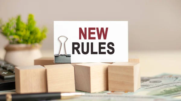 Motivational words: new rules. Piece of paper with the text: new rules. Business and finance concept.