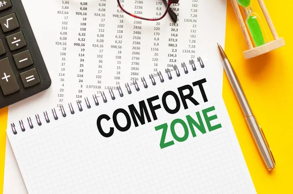 Writing text showing comfort zone. Writing text comfort zone on white paper card, green and black letters, yellow background. Business concept.