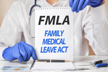 Doctor's hands in blue gloves holding a sheet of paper with text flma. fmla - short for family medical leave act, medical concept clipart