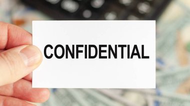 Motivational words: CONFIDENTIAL. Man holds a piece of paper with the text: corporate bonds. Business and finance concept
