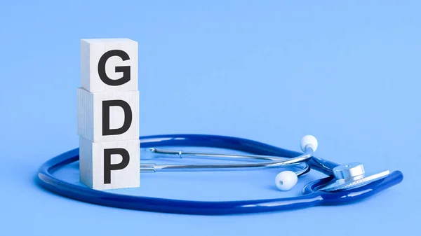 Gdp Woord Geschreven Houten Blokken Stethoscoop Lichtblauwe Achtergrond Verzekering Medisch — Stockfoto