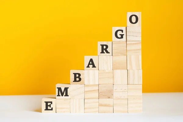 The word embargo is written on a wooden cubes, concept — Stock Photo, Image