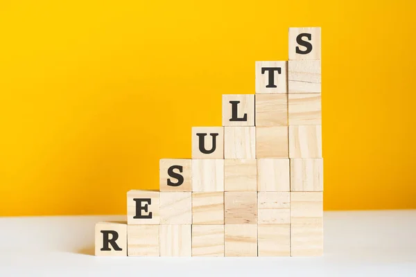 Word Results Written Wooden Cubes Blocks Bright Yellow Background Corporate — Stock Photo, Image