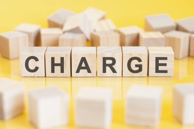 the word charge is written on a wooden cubes structure. blocks on a bright background. financial concept. selective focus