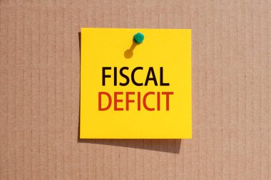 business phrase - fiscal deficit - written on yellow square paper and pinned on paperboard, concept
