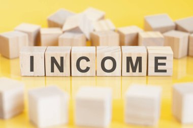 the word charge is written on a wooden cubes structure. blocks on a bright background. financial concept. selective focus