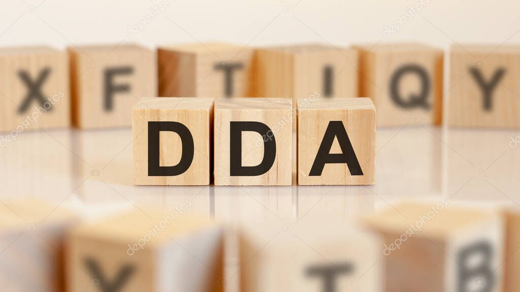 DDA - acronym from wooden blocks with letters, Doha Development Agenda or doing business as abbreviation DDA concept, random letters around, yelllow background