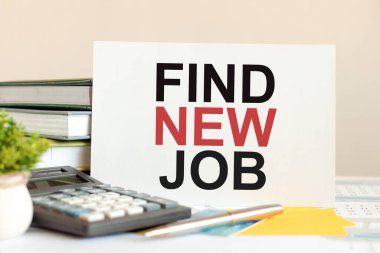 Metni olan beyaz kağıt parçası masanın üzerinde kitapların arka planına karşı duran yeni bir iş buluyor, seçici odaklanma