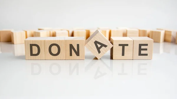 Donate Word Wooden Blocks Letters Gray Background Reflection Caption Mirrored — Stock Photo, Image