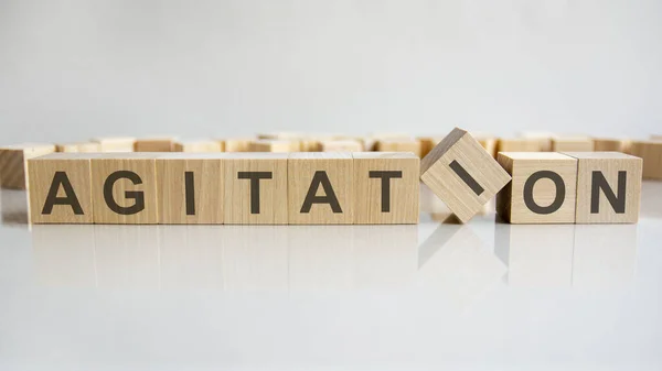 Agitation Word Wooden Blocks Letters Gray Background Reflection Caption Mirrored — Stock Photo, Image