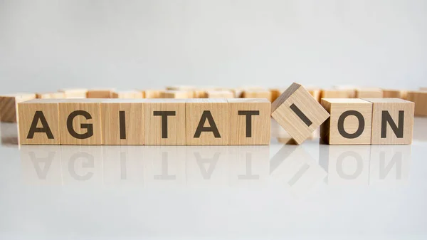 Agitation Word Wooden Blocks Letters Gray Background Reflection Caption Mirrored — Stock Photo, Image