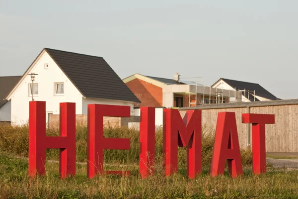 Home Letters in front of Houses. Symbol picture to welcome refugees — Stok fotoğraf