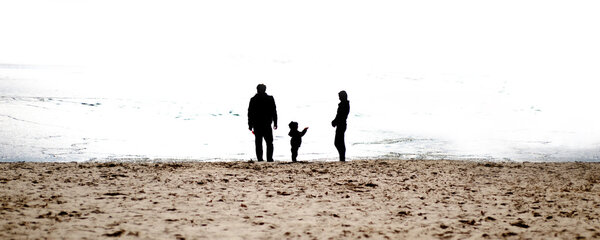 Family silhouettes on the beach in The morning Stock Image