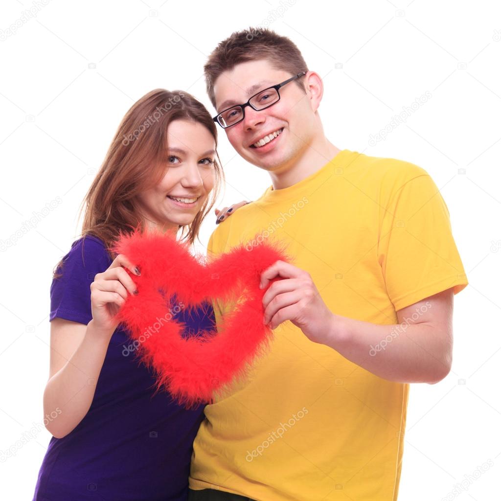 Young couple in love holding heart and cuddle