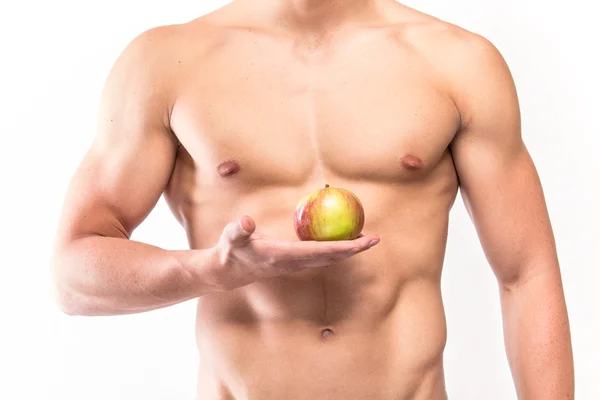 Muscular man holding apple — Stock Photo, Image