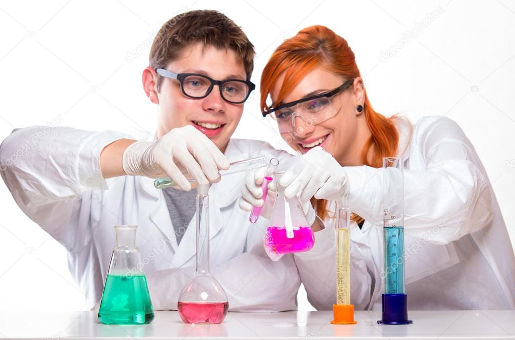 Two students in chemistry lab doing reactions