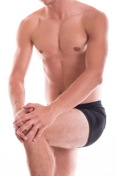 Naked man holding his knee - studio shoot — Stock Photo, Image