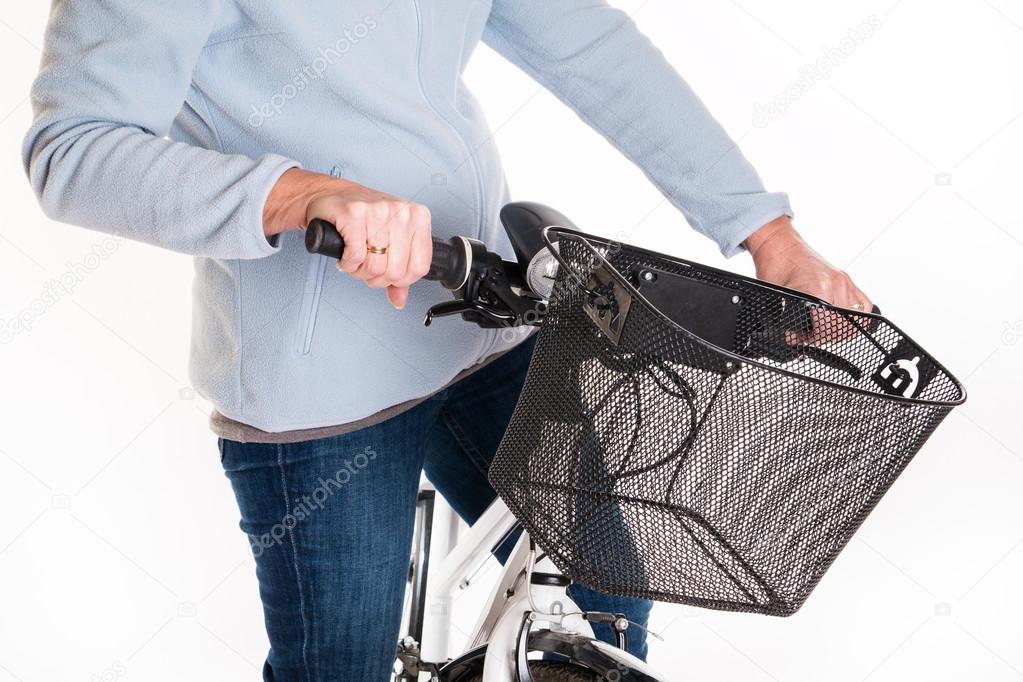 Woman on a bike with a front bicycle basket