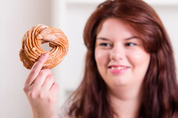 Plump woman eating donut — Stock Photo, Image