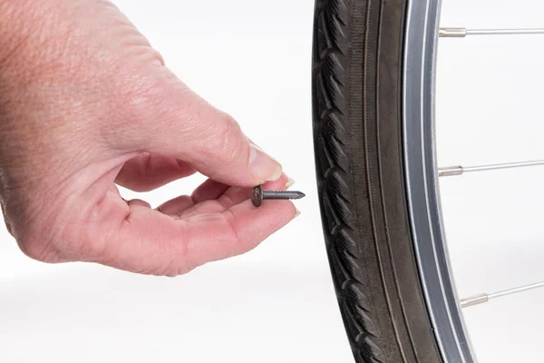 Nail stuck in the tire of the bike — Stock Image Nail stuck in the tire of the bike Stock Image