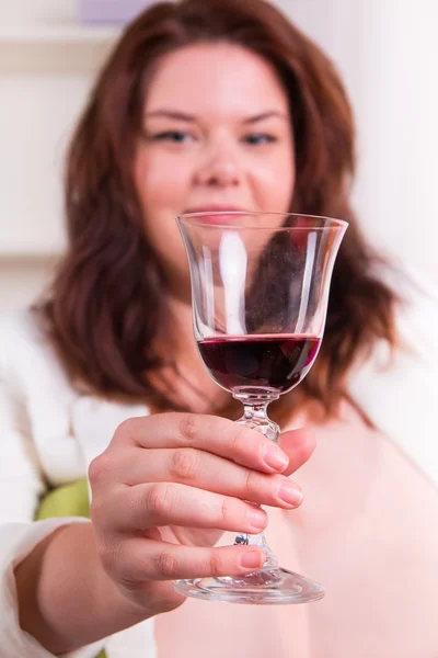 Woman holding a glass of red wine — Stock Photo, Image