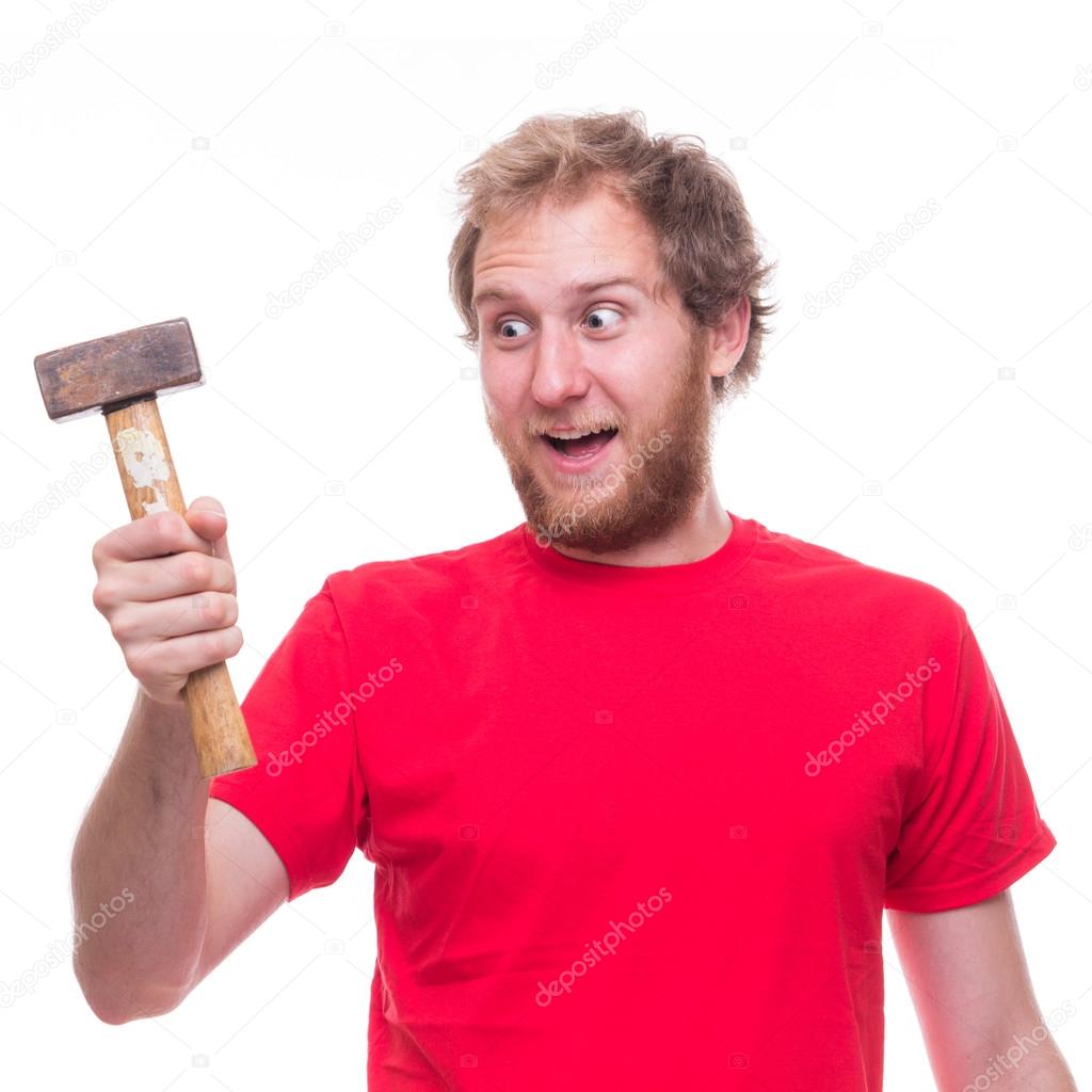 Surprised man holding hammer