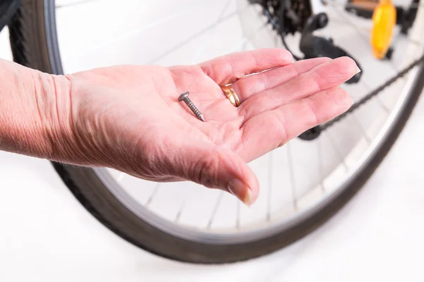 Sharp nail in the wheel of the bicycle — Stock Photo, Image