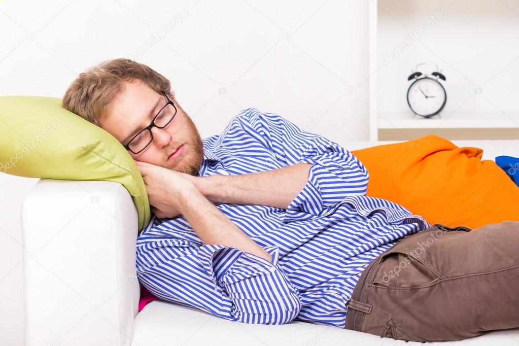 Young man sleeping on couch