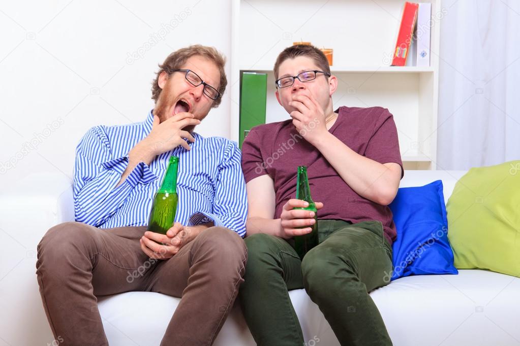 Two bored guys drinking beer