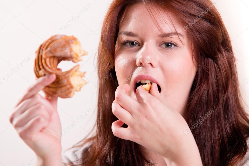Plump woman eating donut