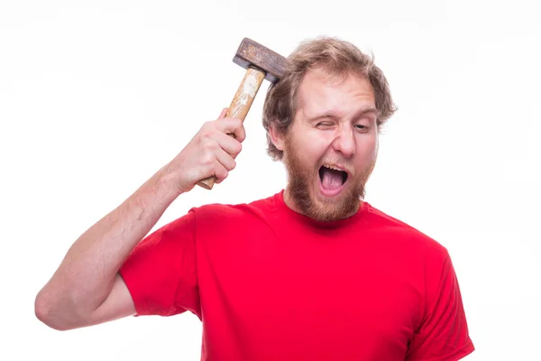 Man strikes his head with hammer — Stock Photo, Image