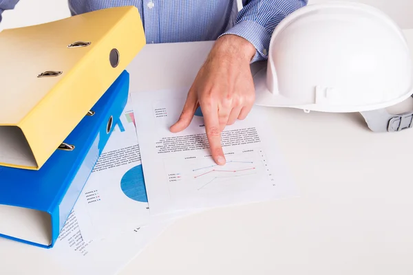 Engineer with papers at desk — Stock Photo, Image