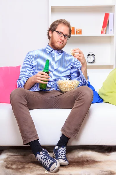 Man med popcorn på soffa — Stockfoto