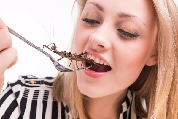 Woman eating insects in restaurant — Stock Photo, Image