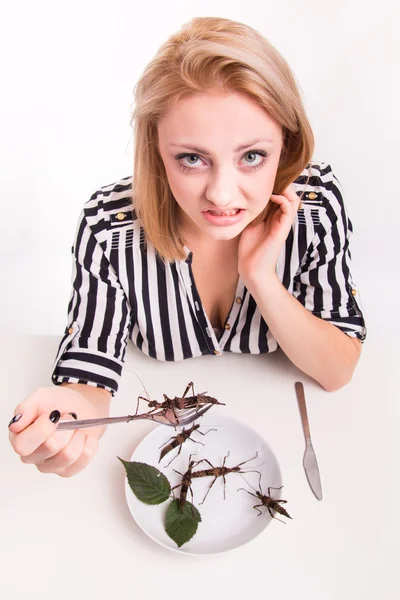 Woman eating insects in restaurant — Stock Photo, Image