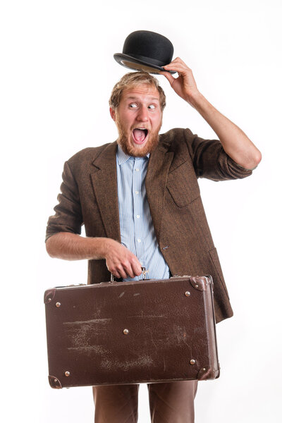 Old-fashioned funny traveler greets by raising his ha