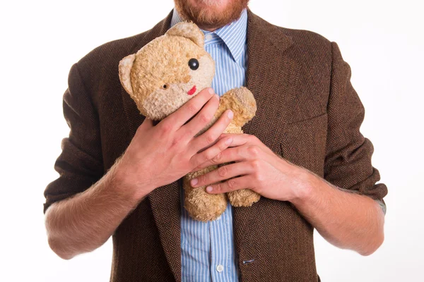 Oude teddybeer in de armen van een man — Stockfoto