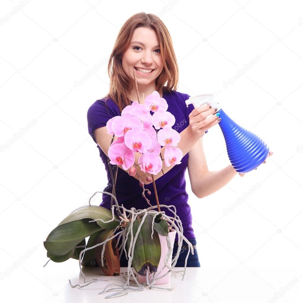 girl watering orchid flowers