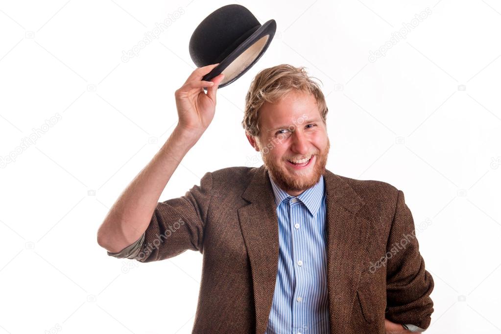 Cheerful bearded man greets by taking off a hat