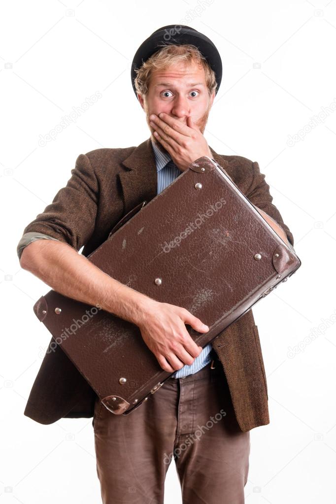 Terrified man with vintage suitcase