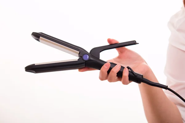 Hair straightener in hand — Stock Photo, Image