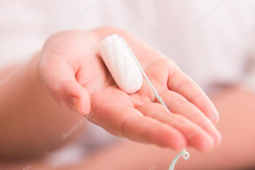 Tampon on womans hand
